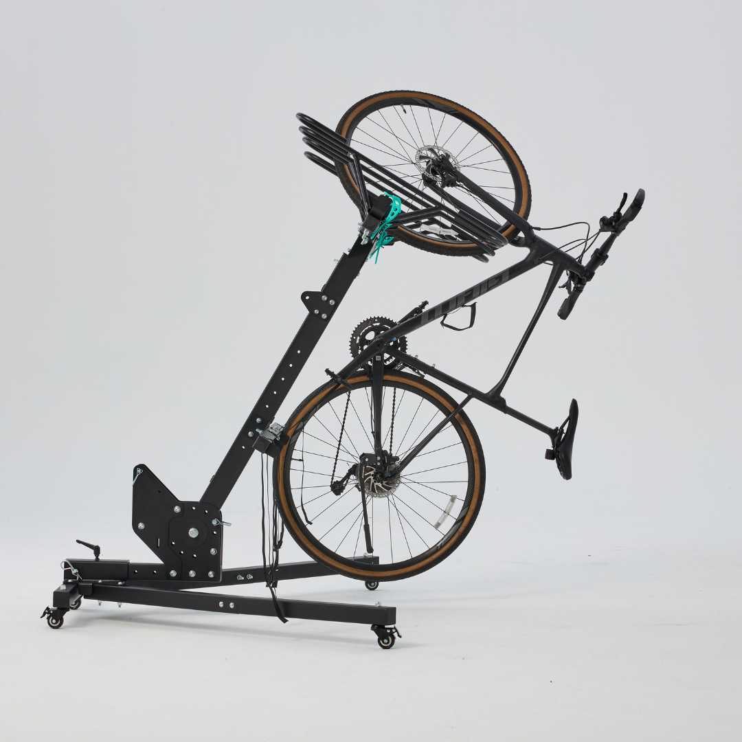 Bicycle mounted on a black bike stand against a white background