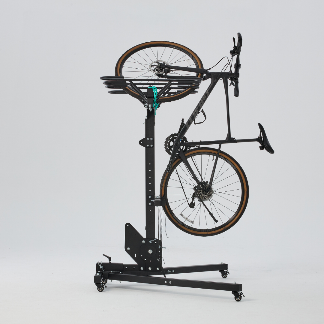 Bicycle mounted on a vertical bike rack against a white background