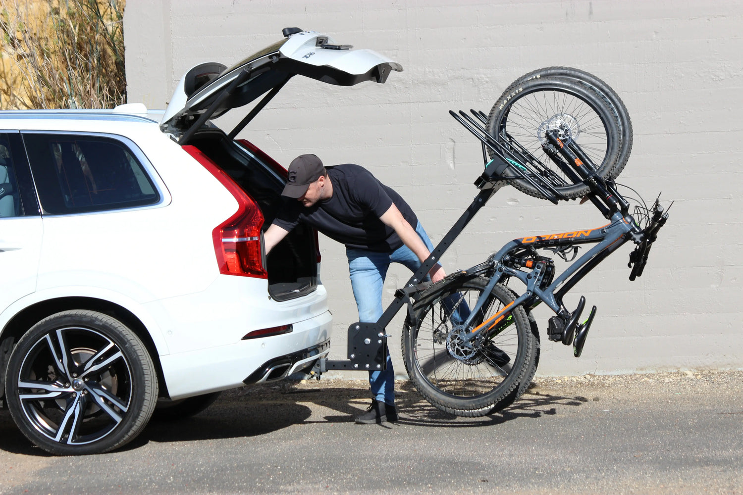 Man opens the trunk of his white SUV with JB Racks